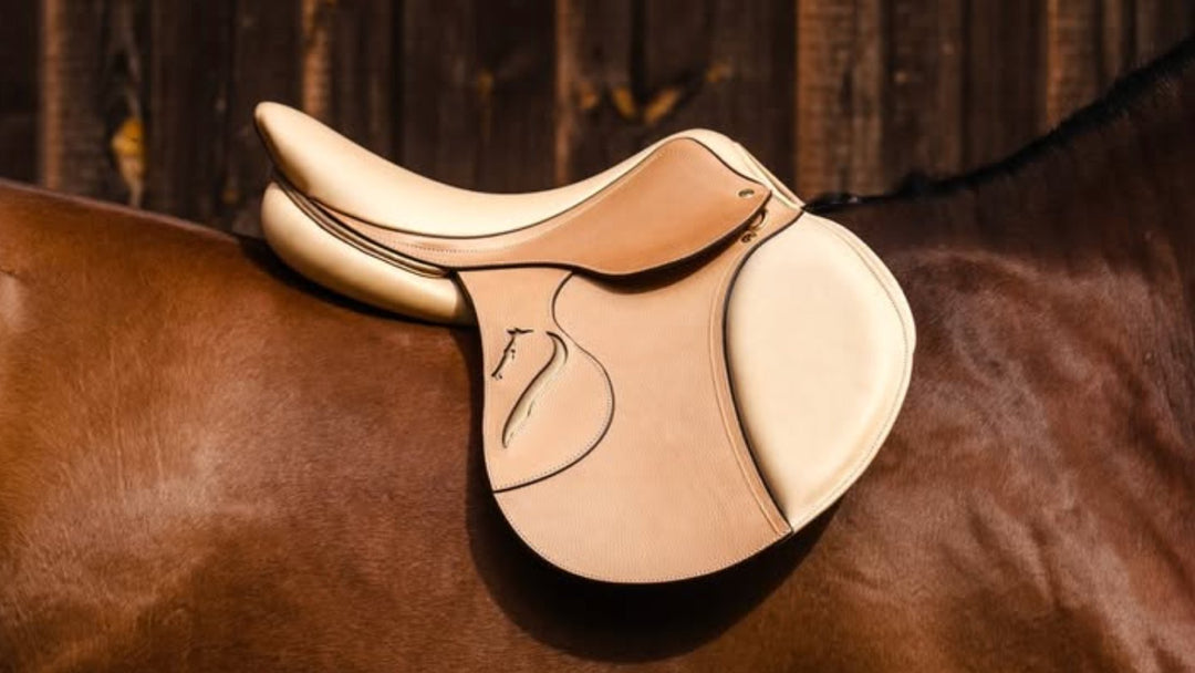 Natural leather close contact jumping saddle on a bay horse