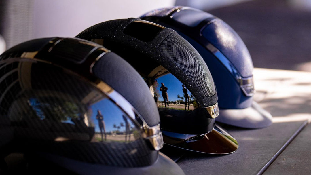 Three KASK riding helmets lined up on a table