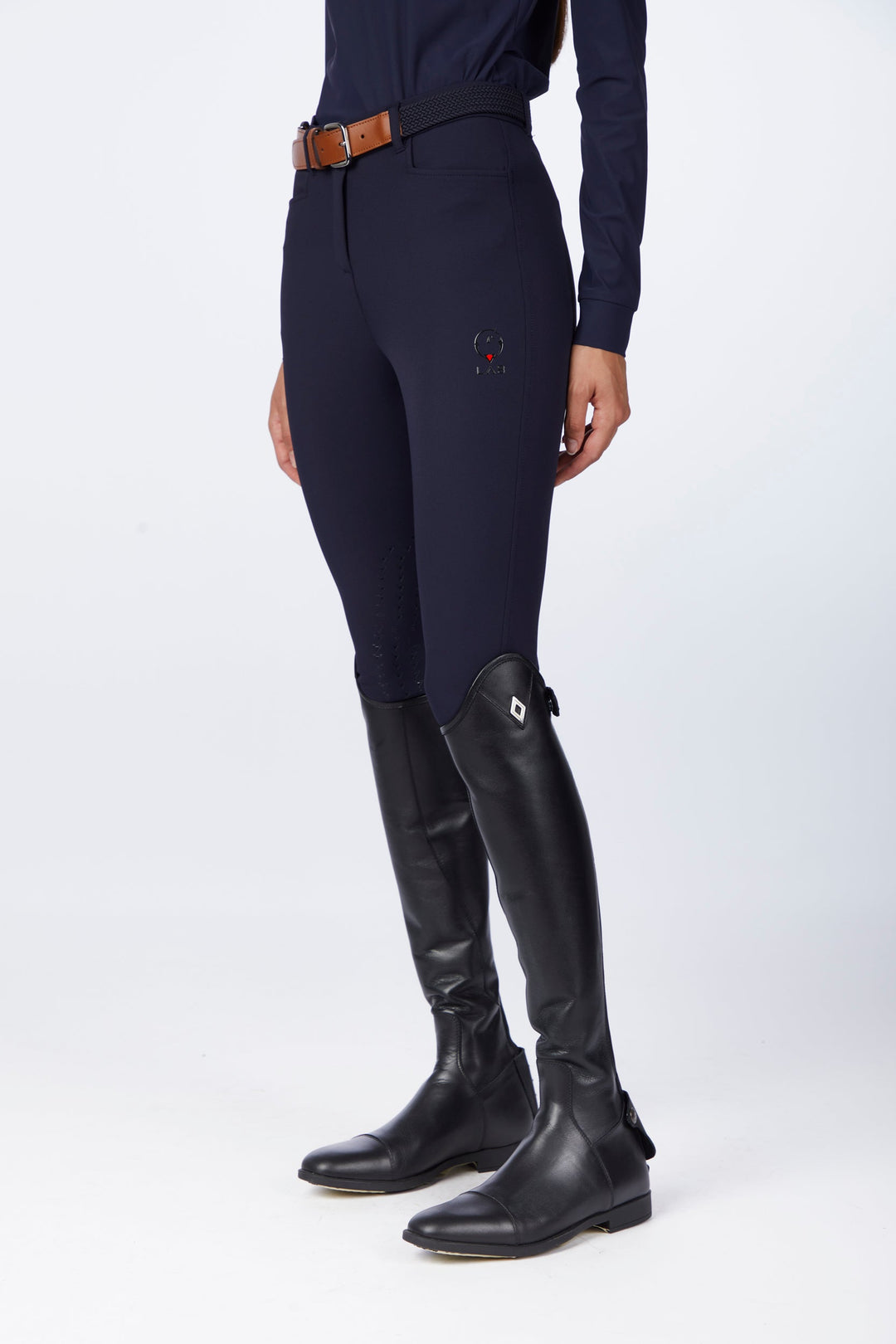 Navy riding breeches worn with tall black leather riding boots